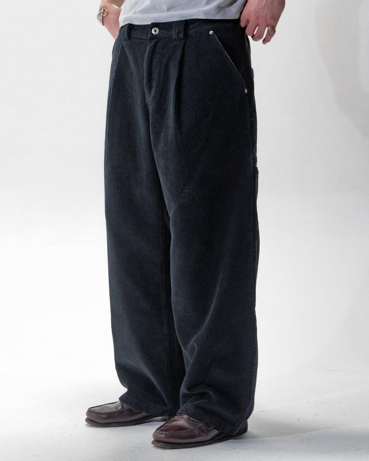 Black corduroy trousers with front pleats and a relaxed fit by WOJO