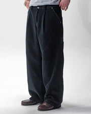 Black corduroy trousers with front pleats and a relaxed fit by WOJO