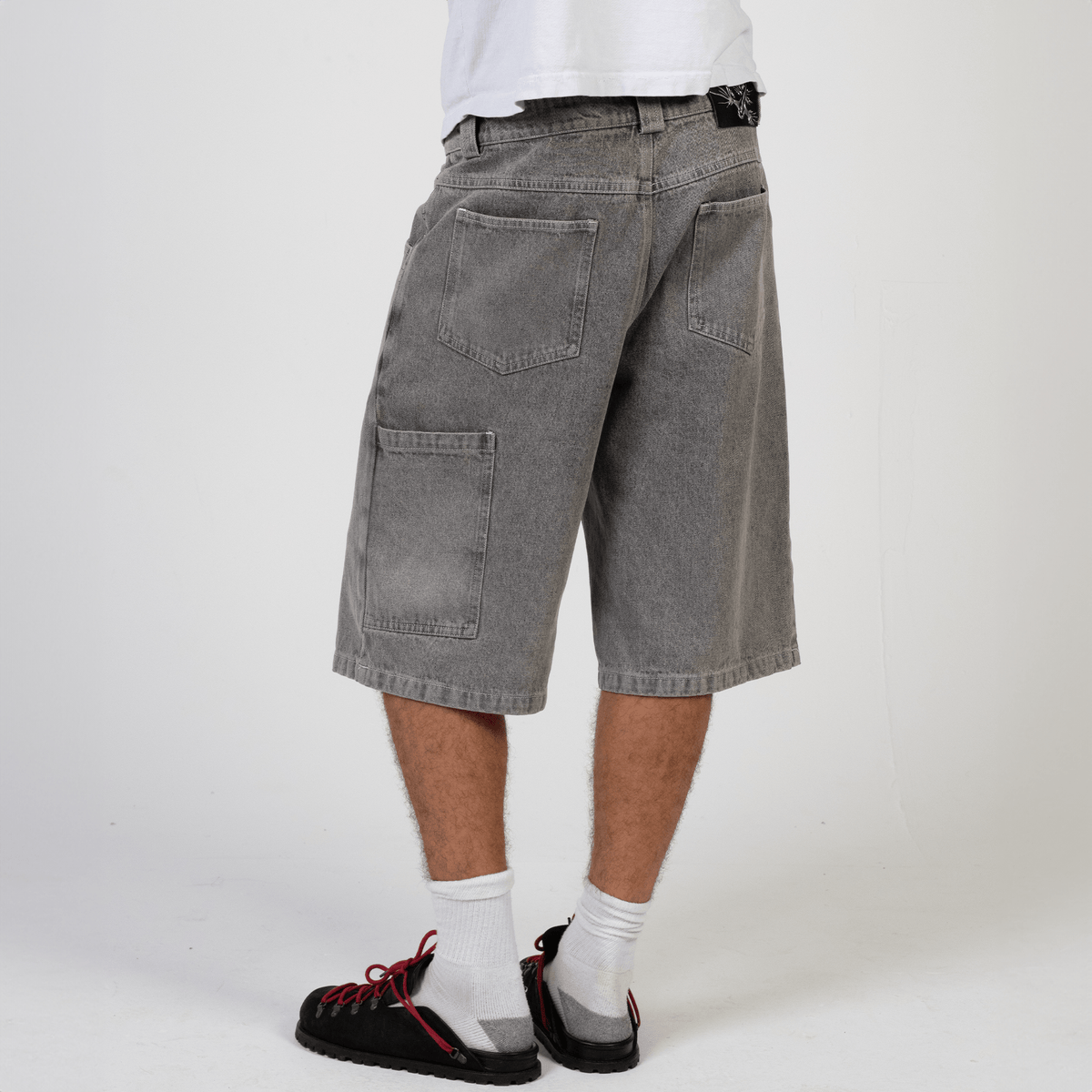 Silver heavyweight denim jorts with chrome leather patch by WOJO