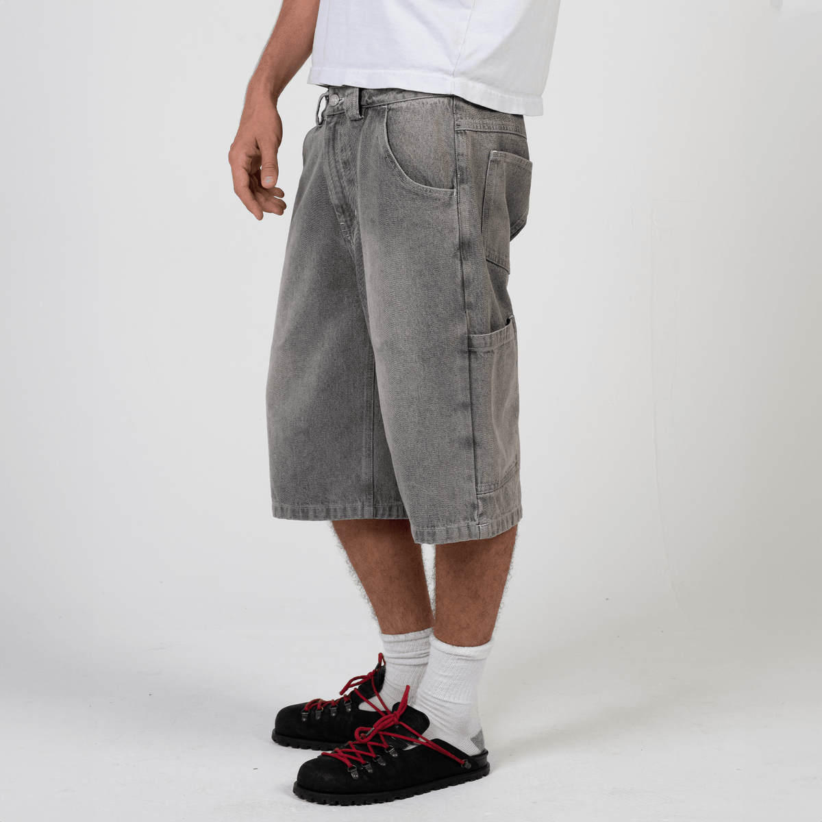Silver heavyweight denim jorts with chrome leather patch by WOJO