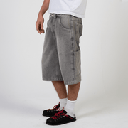 Silver heavyweight denim jorts with chrome leather patch by WOJO