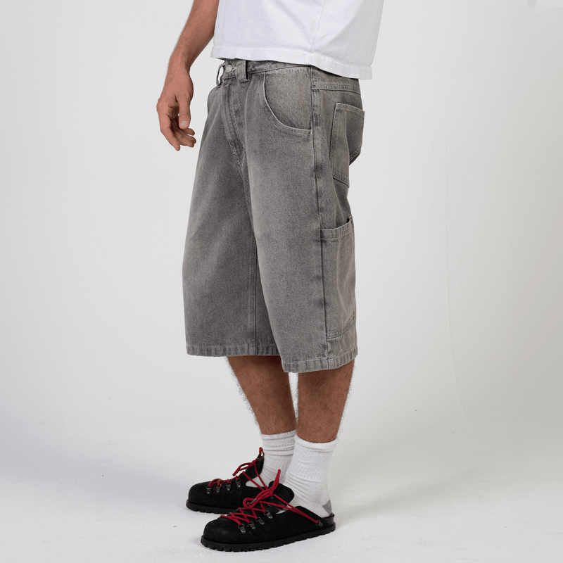 Silver heavyweight denim jorts with chrome leather patch by WOJO