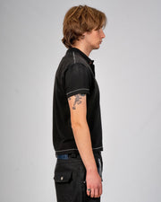 Sunfaded black cotton pique polo with single-stitch details by WOJO