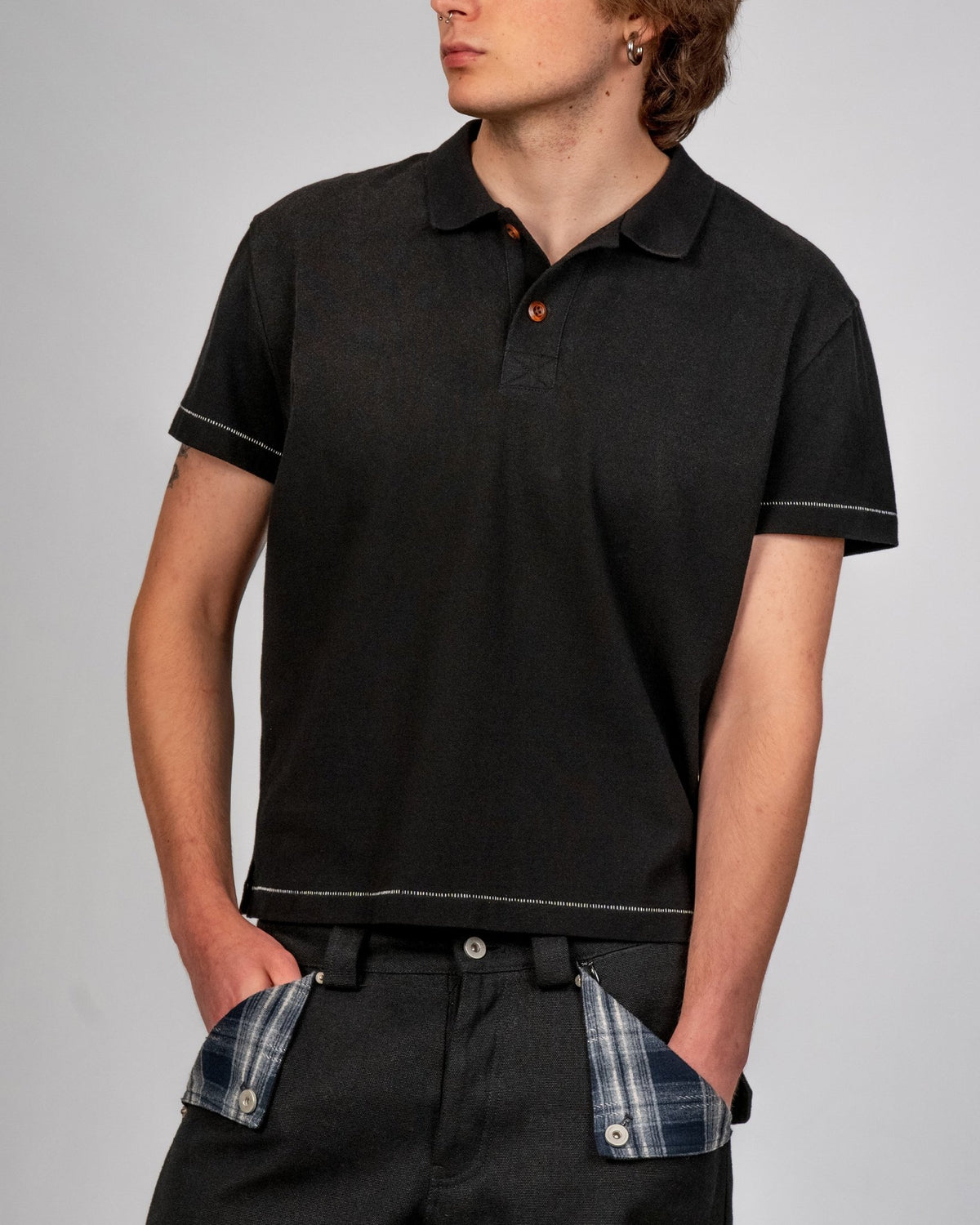 Sunfaded black cotton pique polo with single-stitch details by WOJO